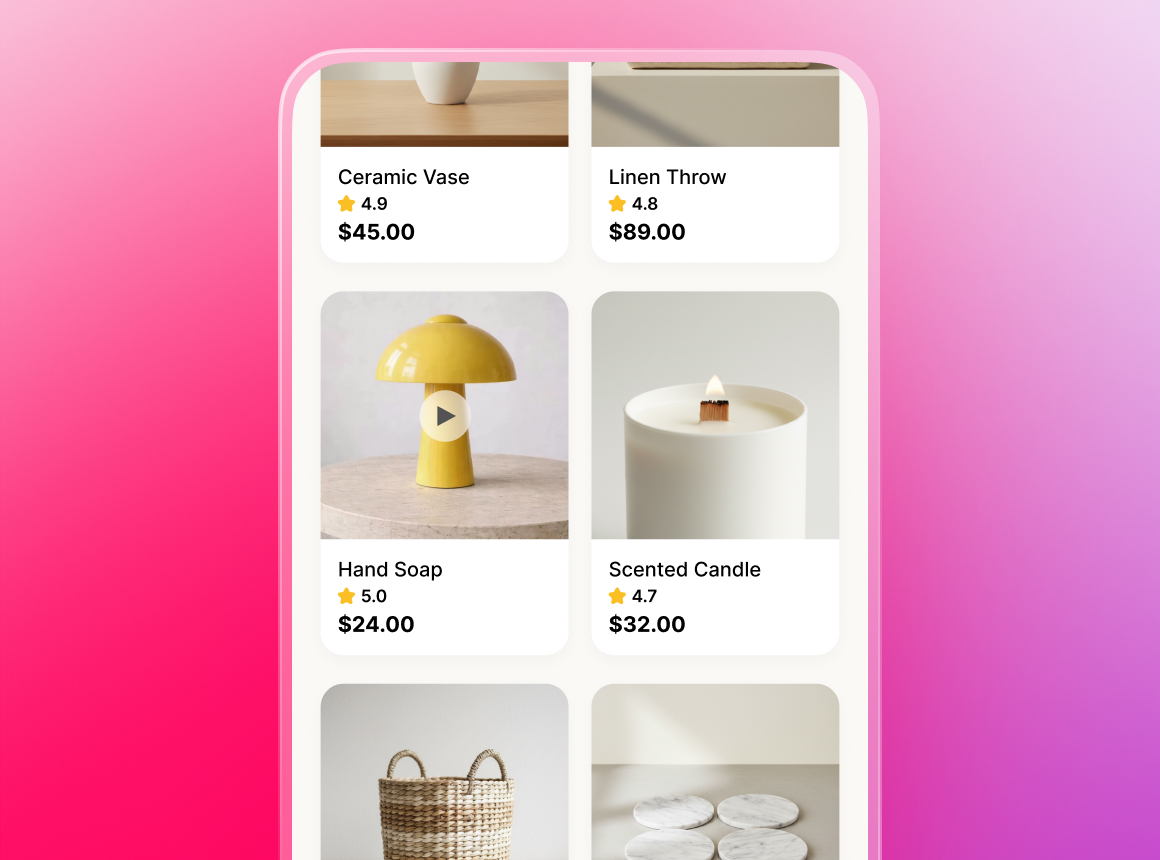 A mockup of a mobile phone screen showing an online store's product feed. The grid includes items with prices and ratings, such as a ceramic vase, a linen throw, a scented candle, and a yellow mushroom lamp that features a video play button overlay.